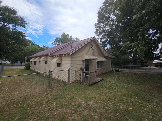 back of house with a lawn