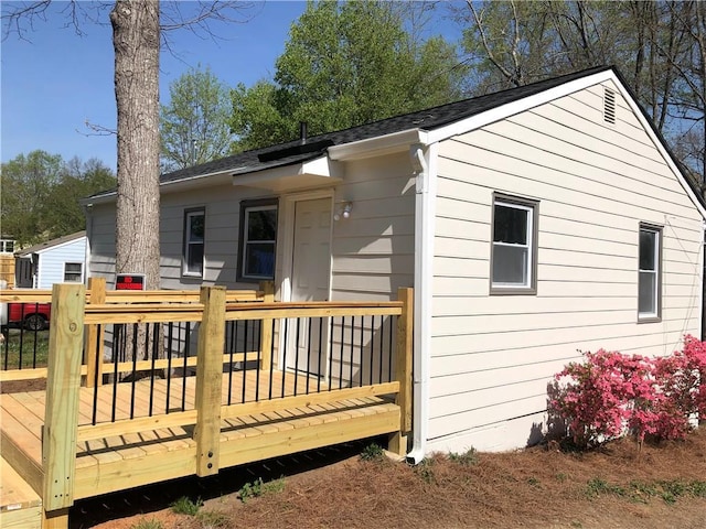 back of property featuring a deck