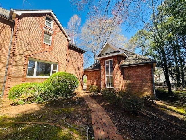 view of side of home featuring fence