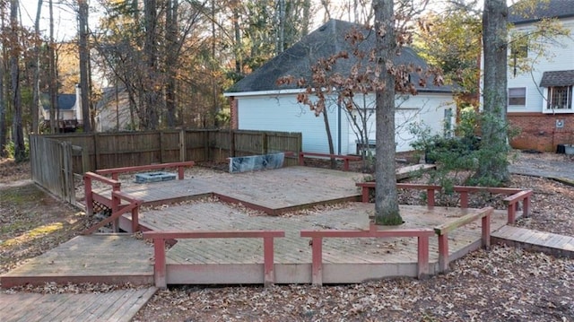 view of yard featuring a wooden deck and fence