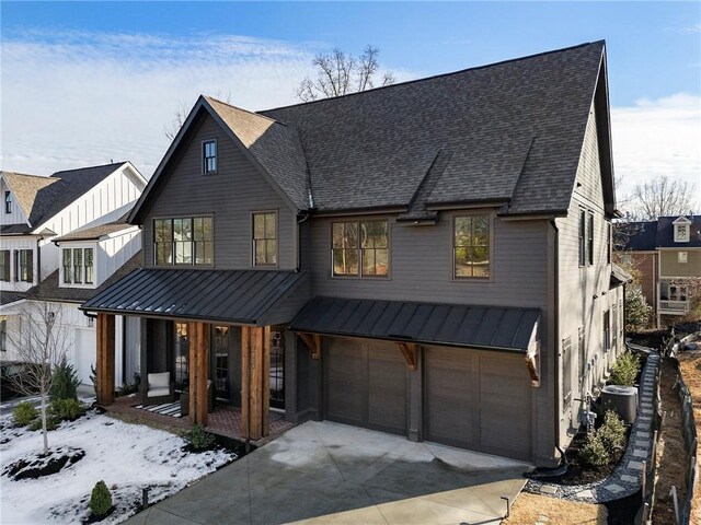 modern farmhouse style home with covered porch, central AC unit, and a garage