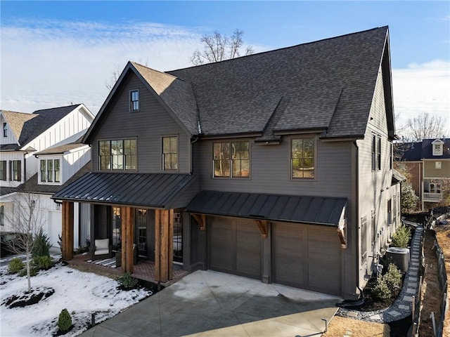 modern farmhouse style home with cooling unit, a garage, and covered porch