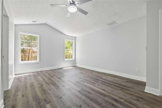 spare room with ceiling fan, a textured ceiling, lofted ceiling, and hardwood / wood-style floors