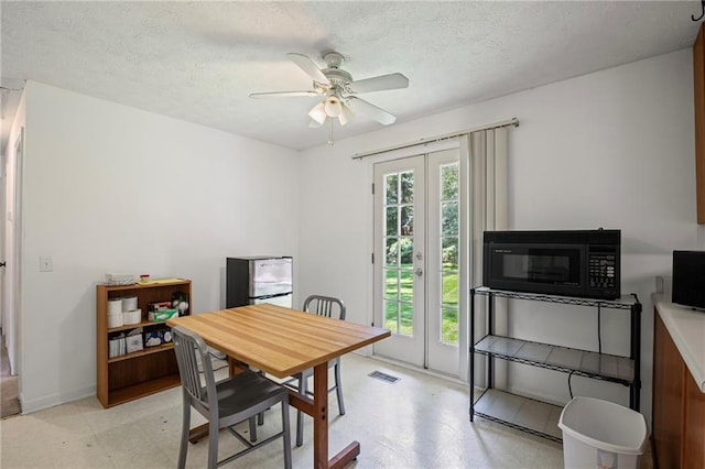 4051 Dixie Ln, Douglasville, GA 30135 - dining space with light flooring, a ceiling fan, and a textured ceiling