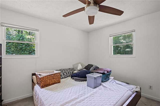 4051 Dixie Ln, Douglasville, GA 30135 - carpeted bedroom featuring a textured ceiling and ceiling fan