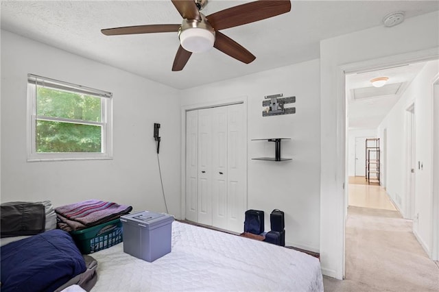4051 Dixie Ln, Douglasville, GA 30135 - bedroom featuring a closet, light carpet, a ceiling fan, and attic access