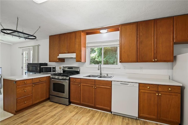 4051 Dixie Ln, Douglasville, GA 30135 - kitchen with stainless steel appliances, under cabinet range hood, a peninsula, light wood finished floors, and light countertops