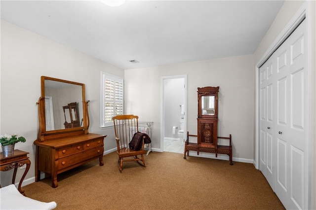 sitting room featuring light carpet