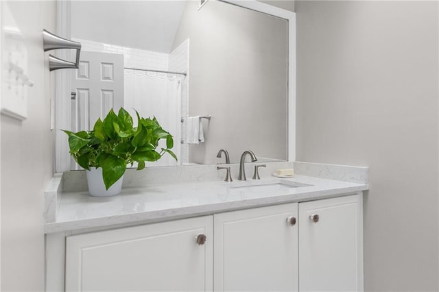 bathroom with vanity and curtained shower