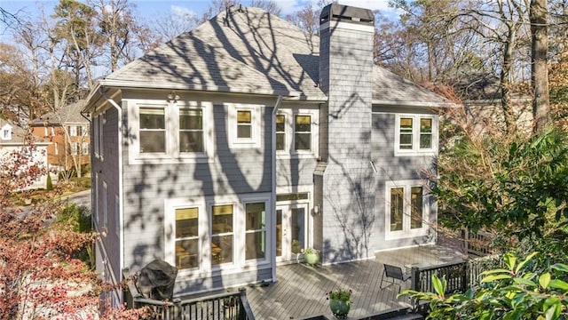 rear view of house featuring a wooden deck