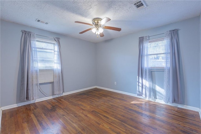 unfurnished room with ceiling fan, dark hardwood / wood-style flooring, and a textured ceiling