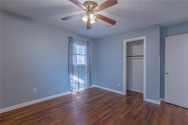 unfurnished bedroom featuring a textured ceiling, dark hardwood / wood-style flooring, a closet, and ceiling fan