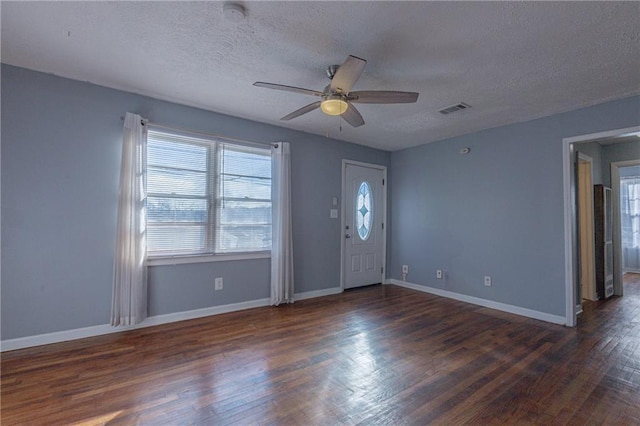 entrance foyer with ceiling fan, dark wood-type flooring, and a textured ceiling