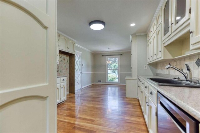 unfurnished living room featuring crown molding, a fireplace, and light wood-type flooring