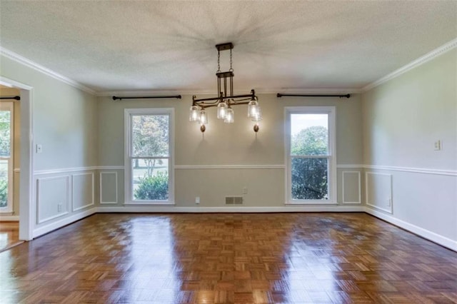 unfurnished dining area with an inviting chandelier, ornamental molding, dark parquet floors, and a textured ceiling