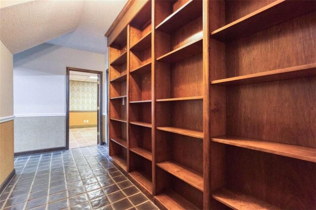 carpeted empty room with crown molding and an inviting chandelier