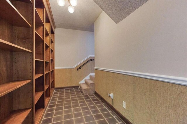 unfurnished bedroom featuring carpet flooring, ceiling fan, crown molding, a textured ceiling, and a closet