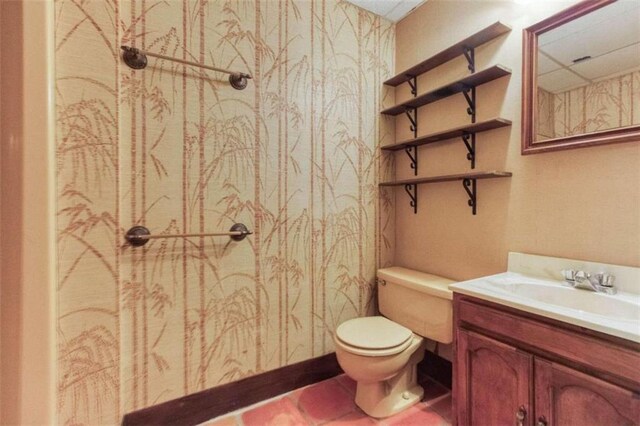 bathroom with vanity, ornamental molding, hardwood / wood-style floors, and toilet