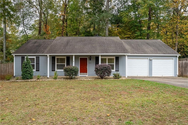 ranch-style home featuring a front lawn, fence, aphalt driveway, a porch, and an attached garage