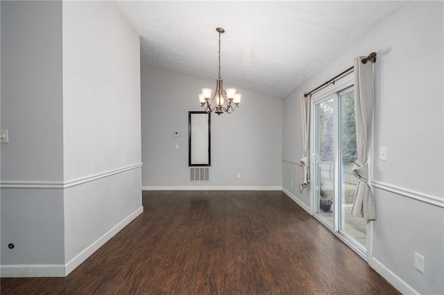 spare room with visible vents, lofted ceiling, baseboards, and wood finished floors