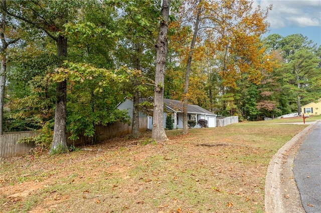 view of home's exterior with a yard and fence