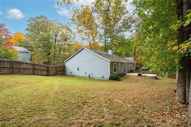 exterior space featuring a lawn and fence