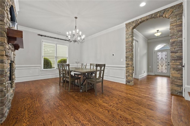 dining space featuring crown molding, plenty of natural light, and wood finished floors