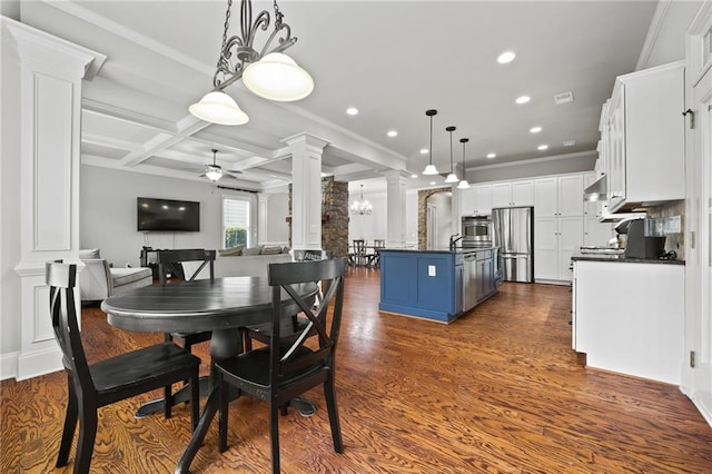 dining area featuring ceiling fan, beam ceiling, coffered ceiling, ornate columns, and dark wood-style flooring