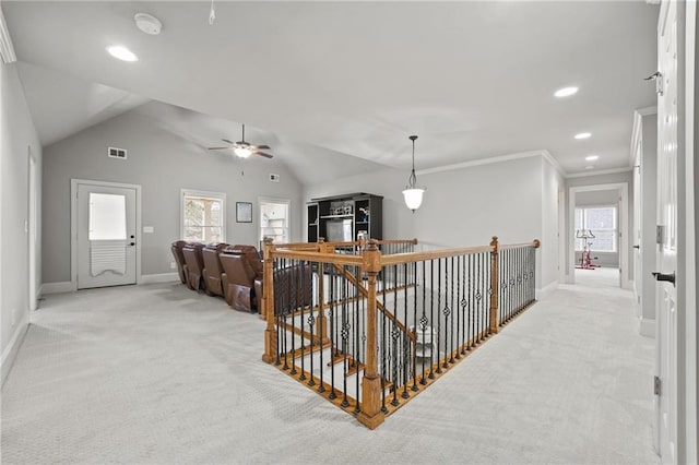 hall featuring baseboards, visible vents, lofted ceiling, light carpet, and an upstairs landing