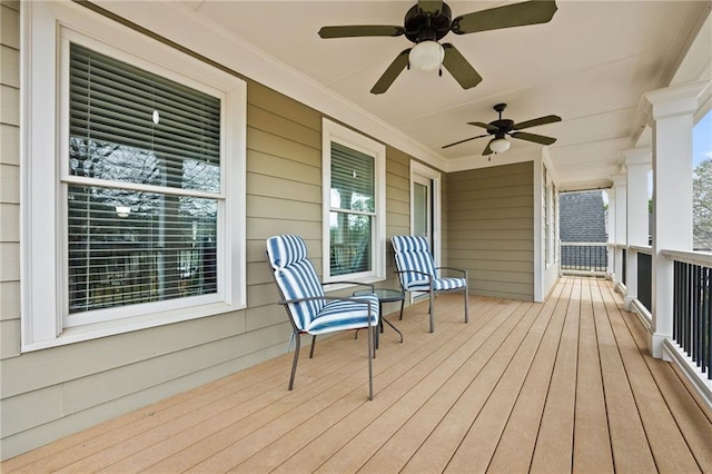 deck with a porch and ceiling fan