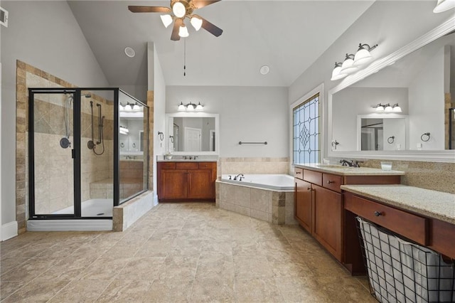 full bath with visible vents, a garden tub, a shower stall, vanity, and vaulted ceiling