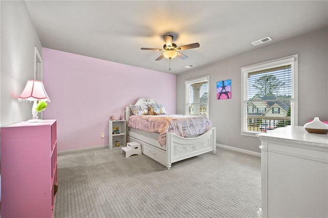 bedroom with visible vents, light carpet, baseboards, and ceiling fan