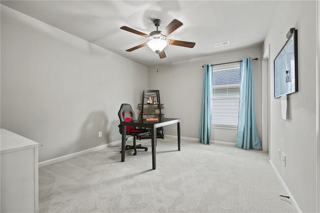 carpeted office space with visible vents, ceiling fan, and baseboards