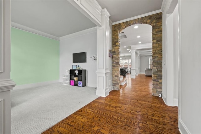 carpeted entryway featuring recessed lighting, arched walkways, ornate columns, and ornamental molding