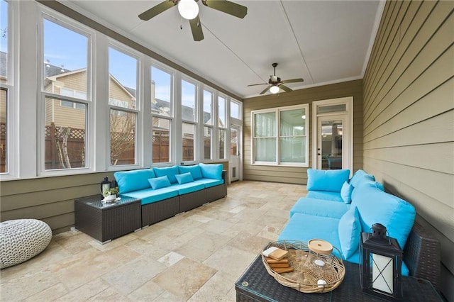 sunroom / solarium with a ceiling fan