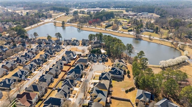 drone / aerial view with a water view and a residential view