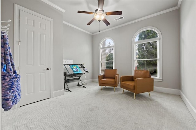 sitting room with visible vents, baseboards, carpet, and crown molding