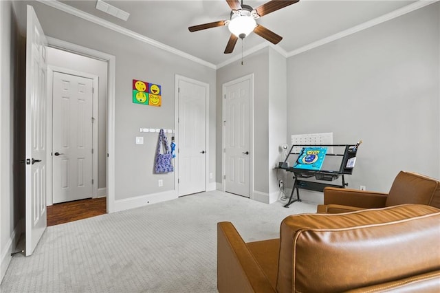 living area with crown molding, baseboards, visible vents, and carpet floors