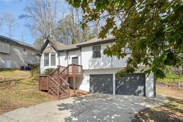 single story home with driveway, a garage, and fence