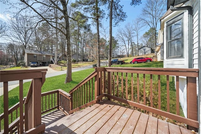 wooden deck with a lawn, a residential view, and covered porch