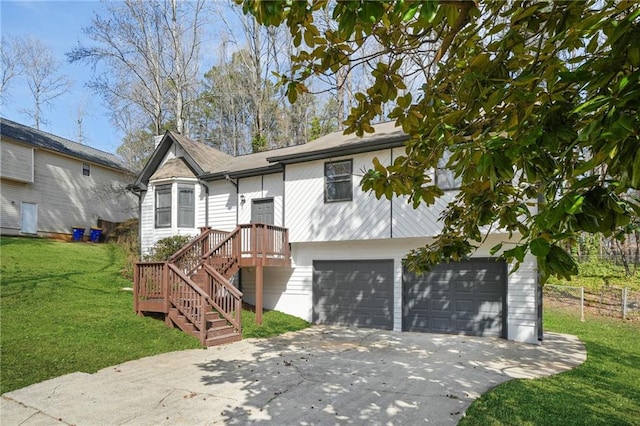 ranch-style home with fence, a garage, a front lawn, and concrete driveway