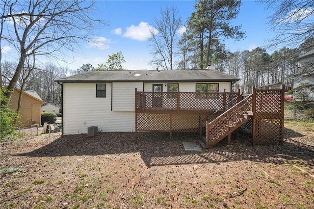 rear view of property featuring stairway, fence, a wooden deck, and central AC