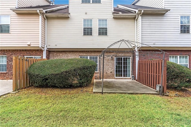 back of house featuring a yard and a patio