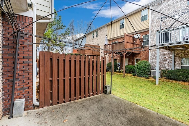 view of gate with a lawn