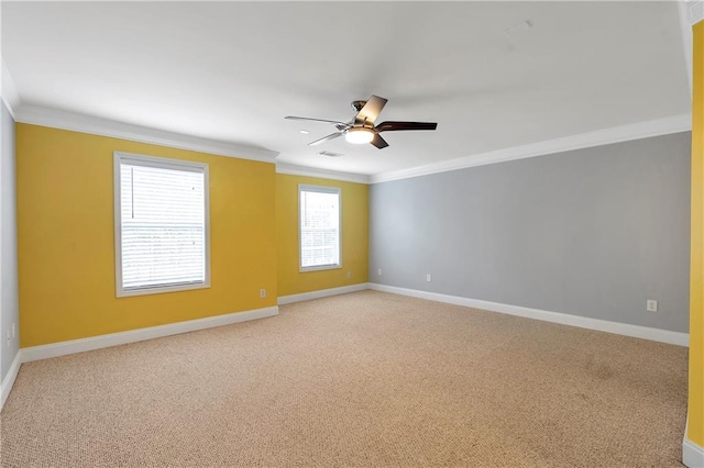 spare room featuring carpet flooring, ceiling fan, and crown molding