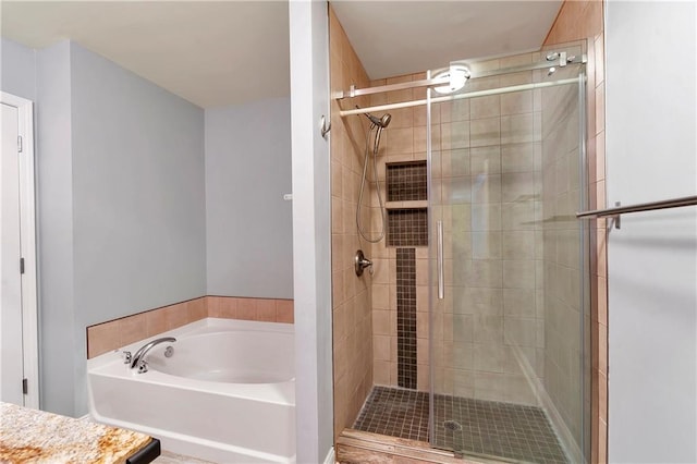 bathroom with vanity and independent shower and bath