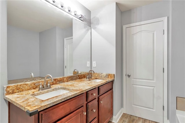 bathroom with hardwood / wood-style floors and vanity