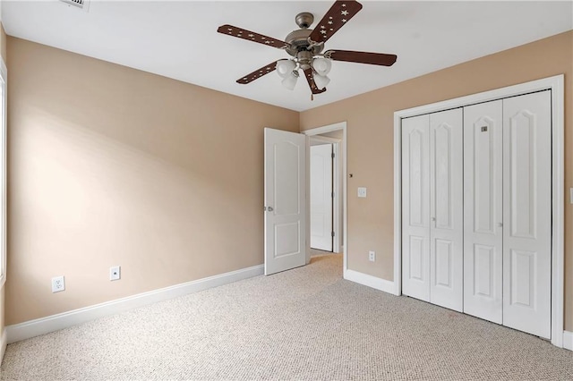 unfurnished bedroom with ceiling fan, a closet, and carpet