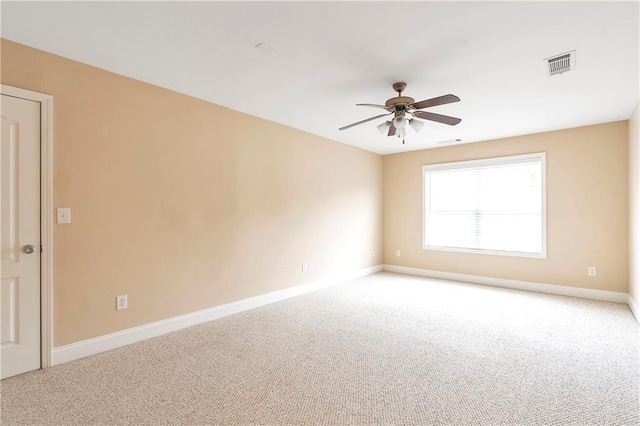 carpeted spare room featuring ceiling fan