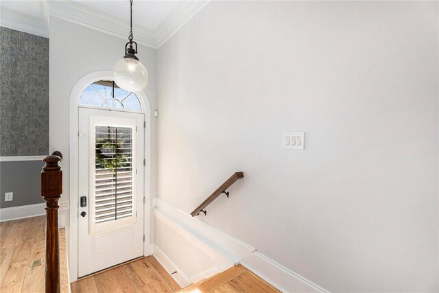 entryway featuring crown molding and light hardwood / wood-style floors